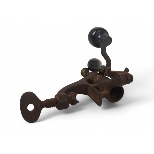 14 - A 19th century shotgun cartridge loading tool - cast iron with brass fittings and ebony handles.