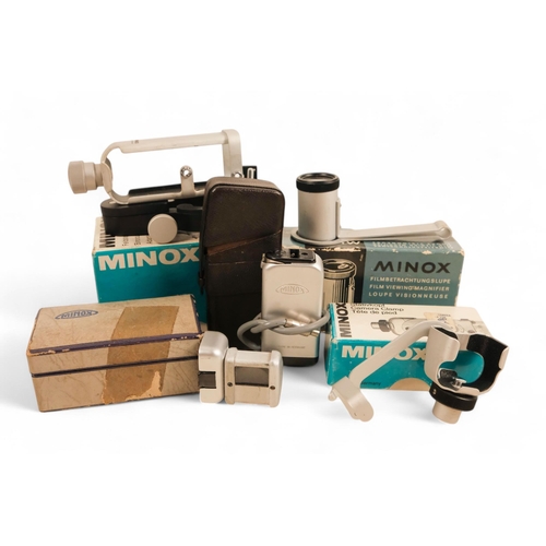 141 - A collection of Minox camera accessories - including camera clamp, viewing magnifier, binocular atta... 