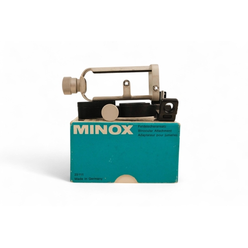 141 - A collection of Minox camera accessories - including camera clamp, viewing magnifier, binocular atta... 