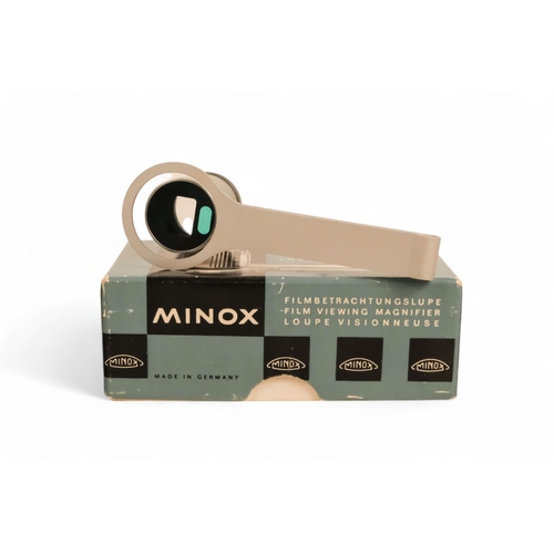 142 - A collection of Minox camera accessories - including camera clamp, viewing magnifier, binocular atta... 