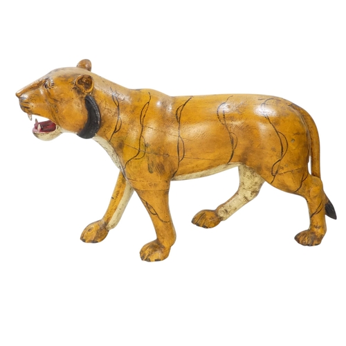 154 - A 20th century carved hardwood and polychrome painted tiger - 59cm wide, together with another of an... 