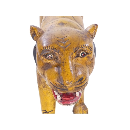 154 - A 20th century carved hardwood and polychrome painted tiger - 59cm wide, together with another of an... 