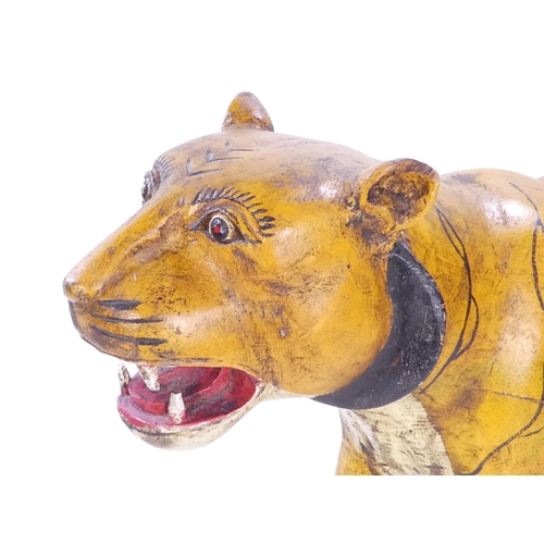 154 - A 20th century carved hardwood and polychrome painted tiger - 59cm wide, together with another of an... 