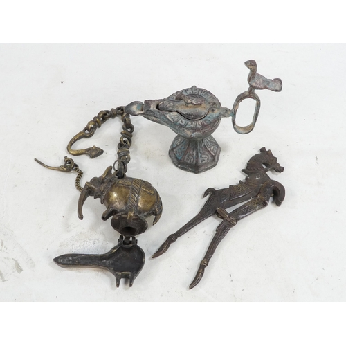 17 - A bronze oil lamp - with bird finials to cover and handle, together with another elephant form oil b... 