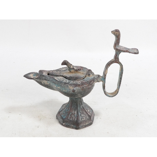 17 - A bronze oil lamp - with bird finials to cover and handle, together with another elephant form oil b... 