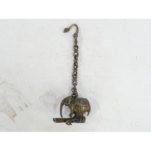 17 - A bronze oil lamp - with bird finials to cover and handle, together with another elephant form oil b... 