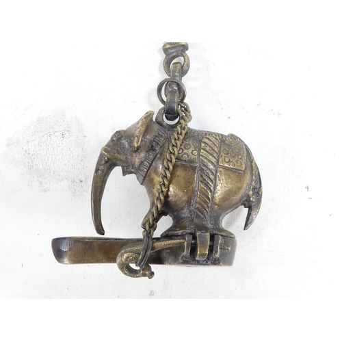 17 - A bronze oil lamp - with bird finials to cover and handle, together with another elephant form oil b... 