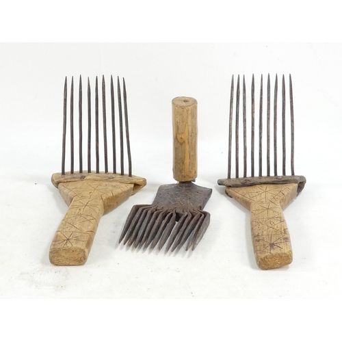 20 - A pair of teasing combs - the tines set in horn and mounted on wooden handles, together with another... 