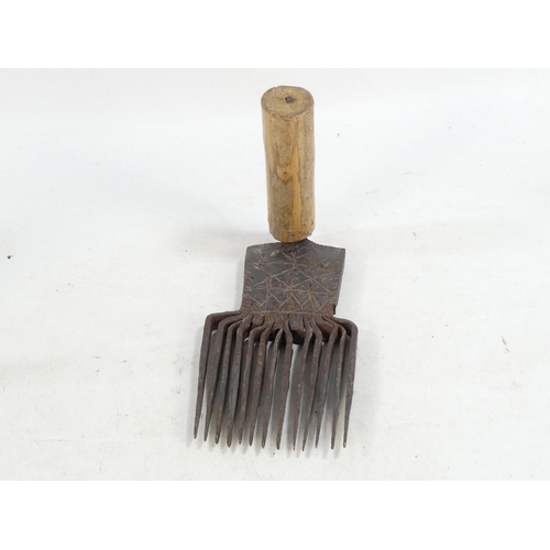 20 - A pair of teasing combs - the tines set in horn and mounted on wooden handles, together with another... 