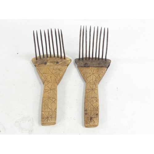 20 - A pair of teasing combs - the tines set in horn and mounted on wooden handles, together with another... 