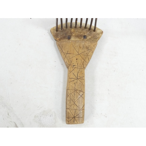 20 - A pair of teasing combs - the tines set in horn and mounted on wooden handles, together with another... 