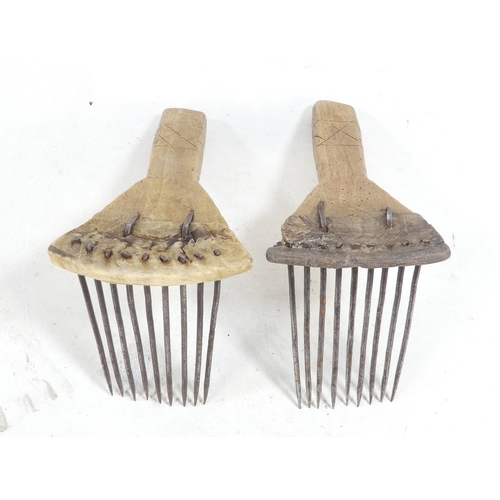 20 - A pair of teasing combs - the tines set in horn and mounted on wooden handles, together with another... 