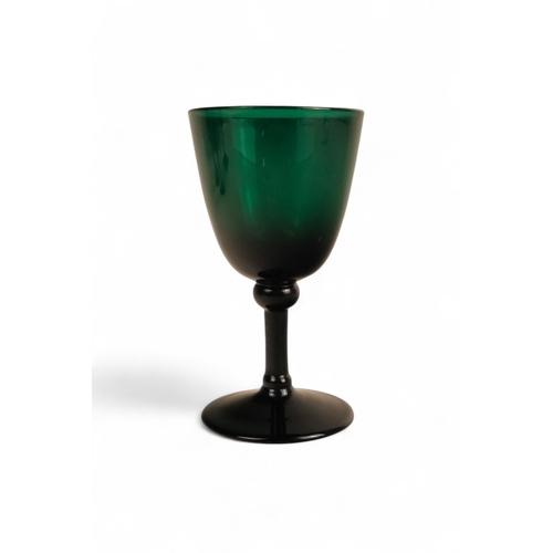 230 - A set of green glasses - with U-shaped bowls and raised on a narrow stems and circular foot, 14cm hi... 