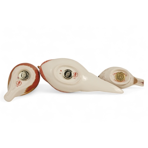 237 - A Royal Crown Derby pheasant paperweight - 7cm high, together with two further birds. (3)