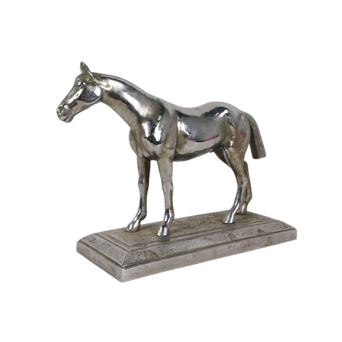 24 - An early 20th century chrome casting of a horse - standing on a rectangular base, 25cm wide.