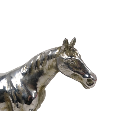 24 - An early 20th century chrome casting of a horse - standing on a rectangular base, 25cm wide.