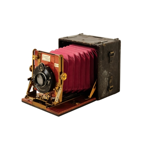 26 - A Sanderson deluxe field camera - the mahogany body with black resin cover, featuring red bellows fi... 