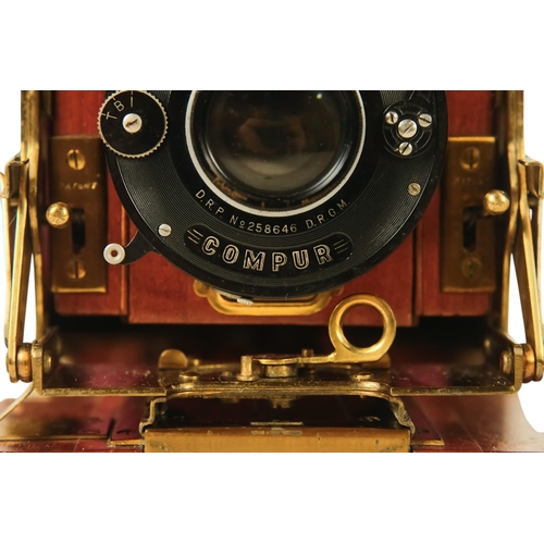 26 - A Sanderson deluxe field camera - the mahogany body with black resin cover, featuring red bellows fi... 