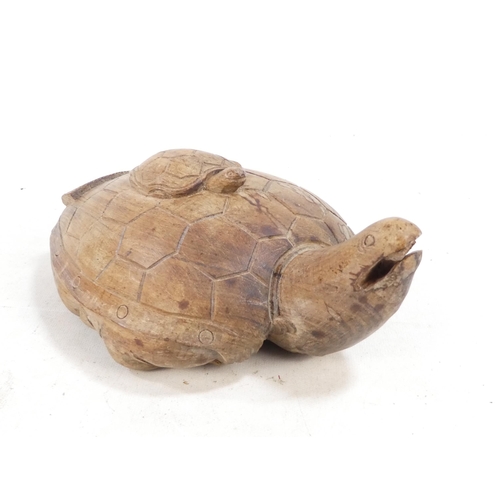 301 - A Chinese caved hardwood deity - the rear carved as a turtle, 20cm high.