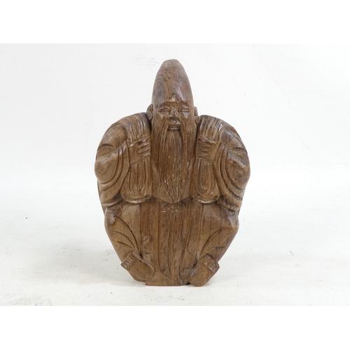 301 - A Chinese caved hardwood deity - the rear carved as a turtle, 20cm high.