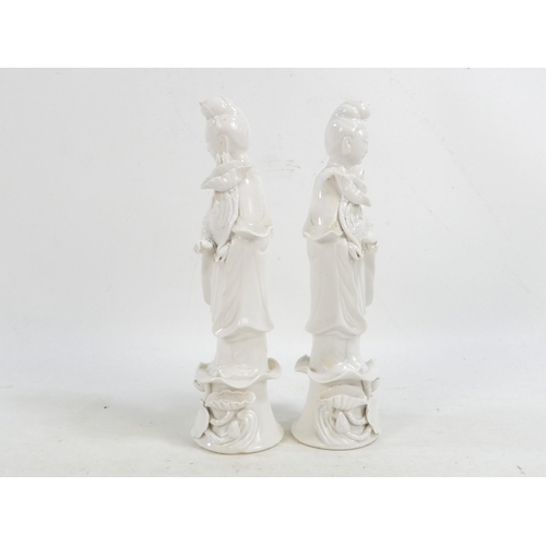 302 - A pair of Chinese Blanc de Chine Guanyin figures - standing on foliate bases and holding lotus flowe... 