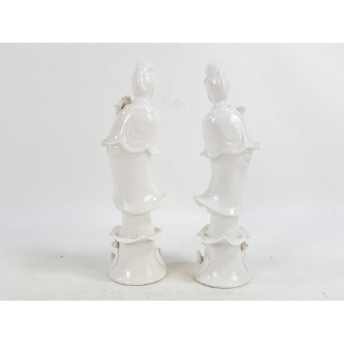 302 - A pair of Chinese Blanc de Chine Guanyin figures - standing on foliate bases and holding lotus flowe... 