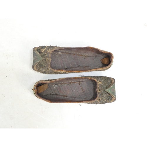 305 - A pair of early 20th century Chinese Manchu platform shoes - the upper with a floral silk design on ... 