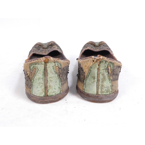 305 - A pair of early 20th century Chinese Manchu platform shoes - the upper with a floral silk design on ... 