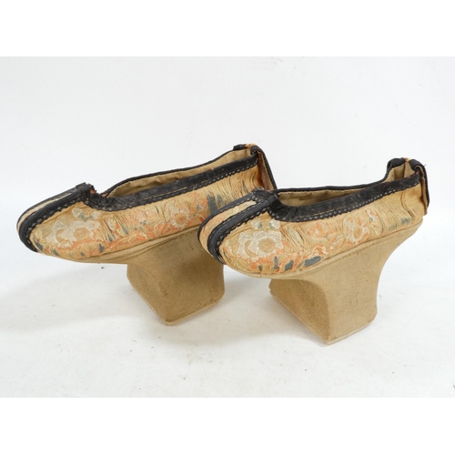 305 - A pair of early 20th century Chinese Manchu platform shoes - the upper with a floral silk design on ... 