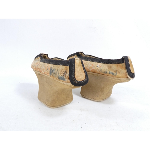 305 - A pair of early 20th century Chinese Manchu platform shoes - the upper with a floral silk design on ... 