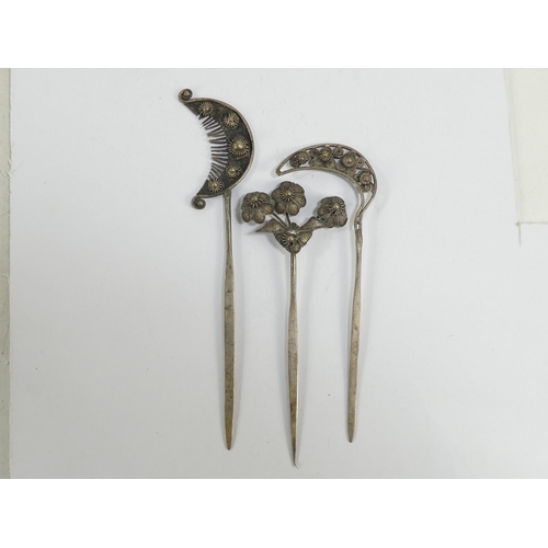 308 - Three various Chinese white metal hair pins - one modelled as blooming flowers, the other two as fol... 