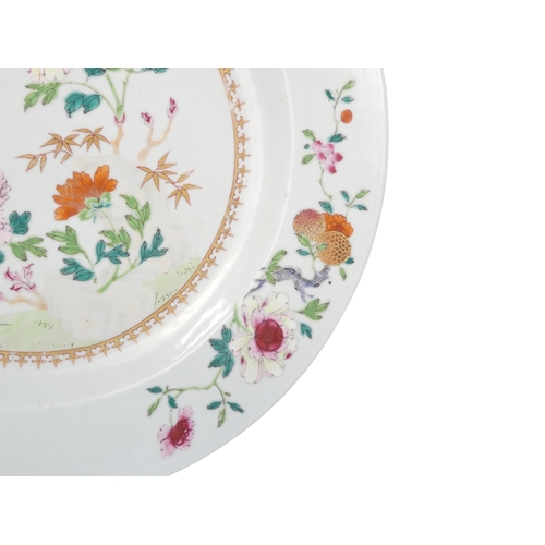 311 - A 19th century famille verte plate - decorated with chrysanthemums, 35cm diameter.