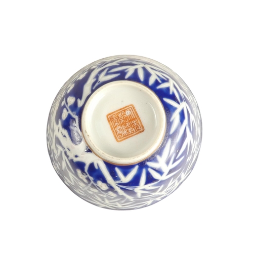 318 - An early 20th century Chinese blue and white rice bowl - with bamboo decoration and seal mark to bas... 