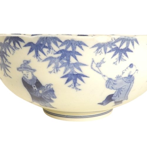 321 - A 19th century Chinese blue and white bowl - decorated with seven figures below wisteria, the centre... 