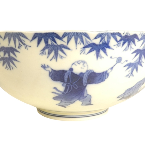 321 - A 19th century Chinese blue and white bowl - decorated with seven figures below wisteria, the centre... 