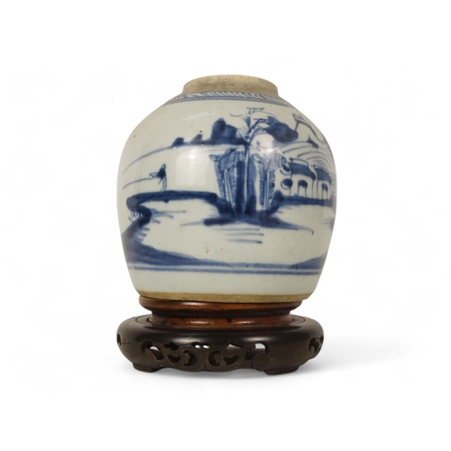 324 - A 19th century blue and white ginger jar - decorated with a river landscape scene, raised on an asso... 