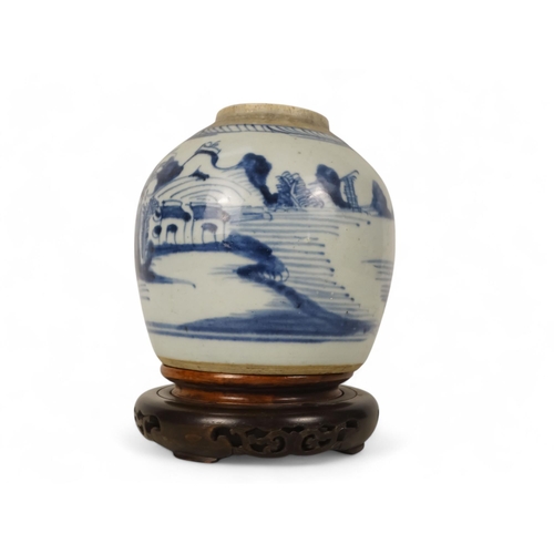 324 - A 19th century blue and white ginger jar - decorated with a river landscape scene, raised on an asso... 