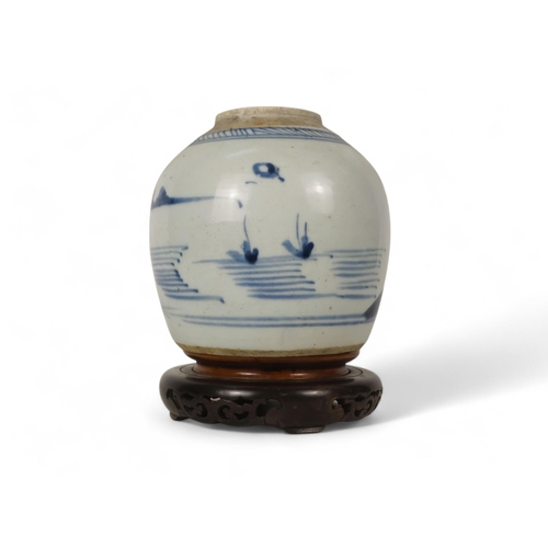 324 - A 19th century blue and white ginger jar - decorated with a river landscape scene, raised on an asso... 