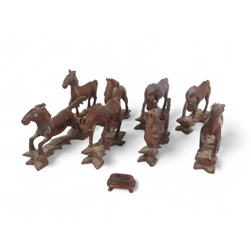 330 - Eight 20th century Japanese carved hardwood horses - arranged in differing poses, 10cm high. (8)