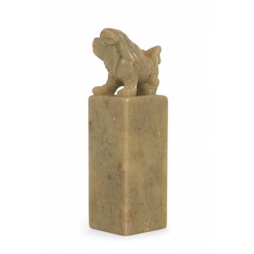 336 - A 20th century Chinese soapstone seal - with square blank matrix and surmounted by a dog of fo, 7cm ... 