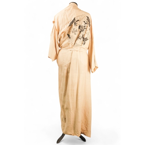 396 - A cream silk dressing gown - embroidered in green with a dragon chasing the flaming pearl and with c... 