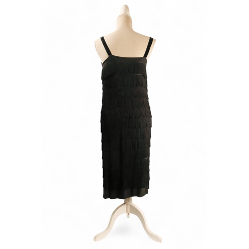 397 - A black 'Flapper' style dress - with black velvet straps, size 10/12, length 90cm.