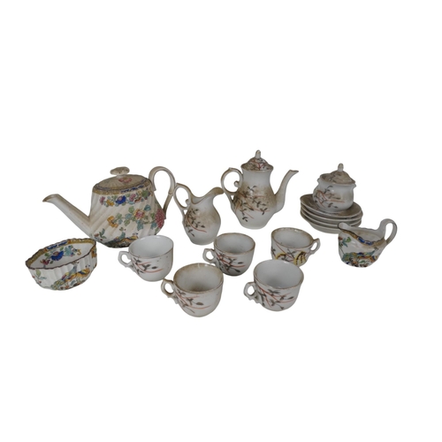 475 - An early 20th century dolls tea service - decorated with foliage on a white ground, comprising five ... 