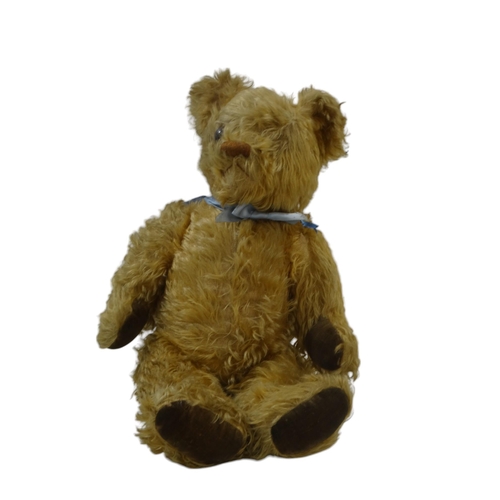 485 - A mid 20th century plush teddy bear - articulated limbs, stitched nose and with pad hands and feet, ... 