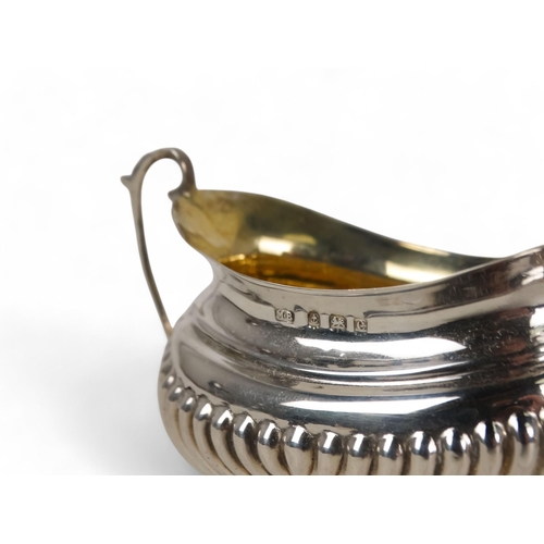 497 - A pair of silver salts - Brimingham 1902, twin handled and part gadrooned with a gilt lining, boxed ... 