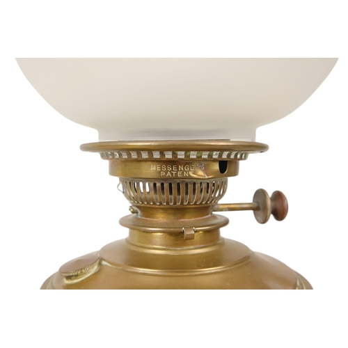 51 - A late 19th century oil lamp - with ruby glass reservoir and fluted baluster support and circular ba... 