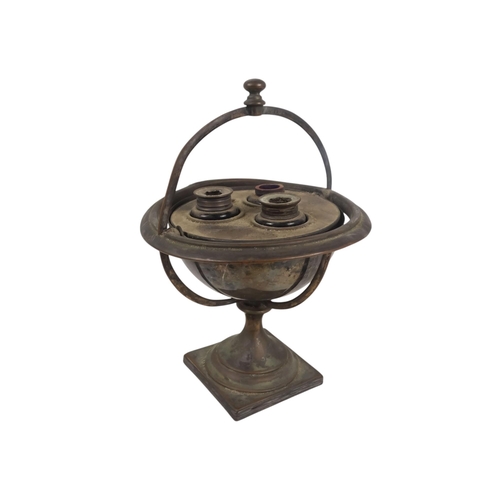 553 - A late 19th century silver plated 'ships' ink stand - of globe form and mounted on a gimble raised o... 