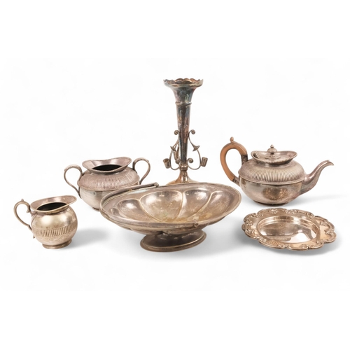 556 - A small quantity of plated wares - including a three piece tea service, part fluted, together with s... 