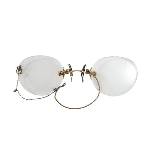 571 - A pair of early 20th century pince-nez - with gilt metal bridge (thought to be 14ct untested).