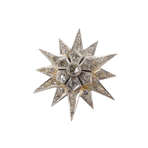 579 - A diamond star pendant/brooch - stepped around a central stone on a twelve point star, 22.1g.